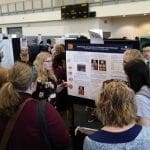 Students giving poster presentation at NCUR in Atlanta