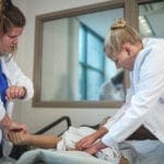 Students gaining experience in the nursing lab