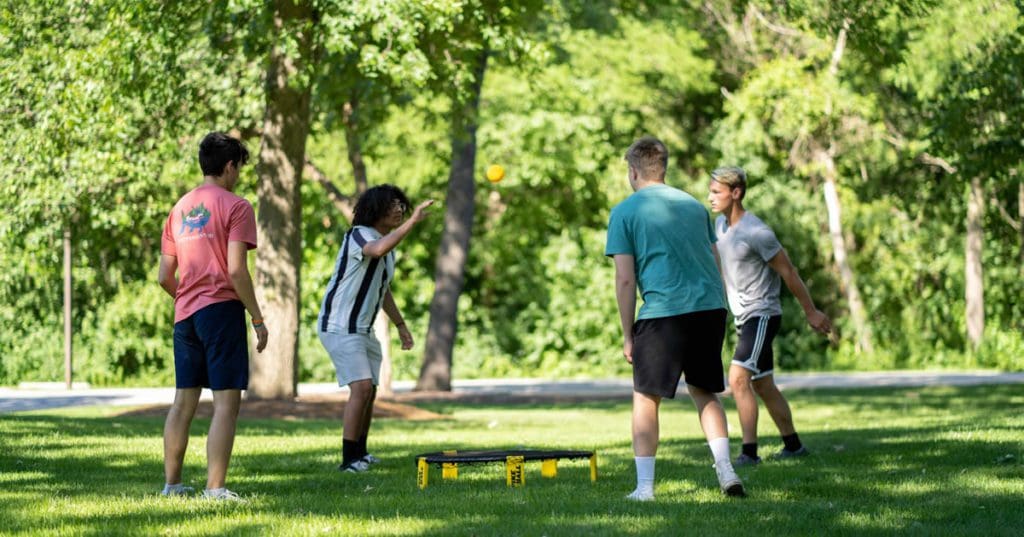 Students playing lawn games outside