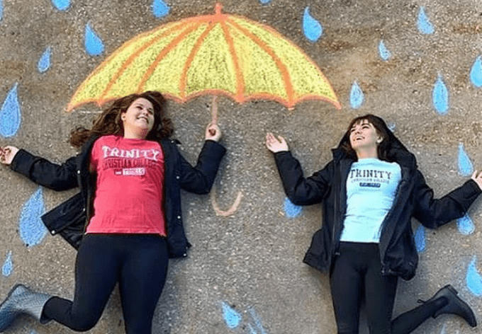 Students showing off their sidewalk chalk art