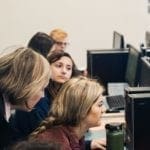 students doing research in the library