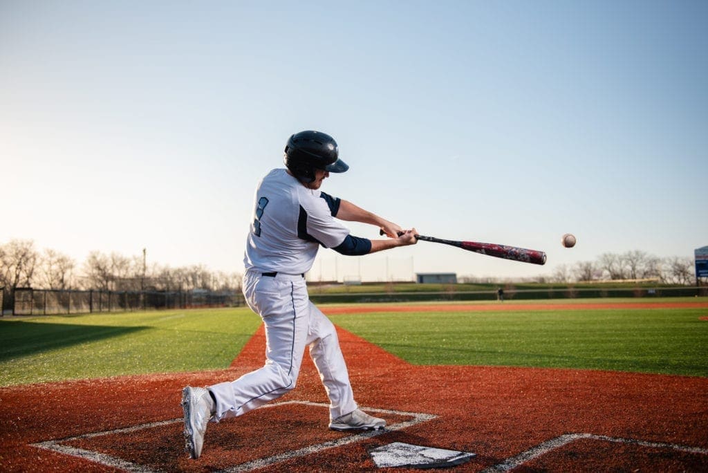 Baseball player swinging at ball