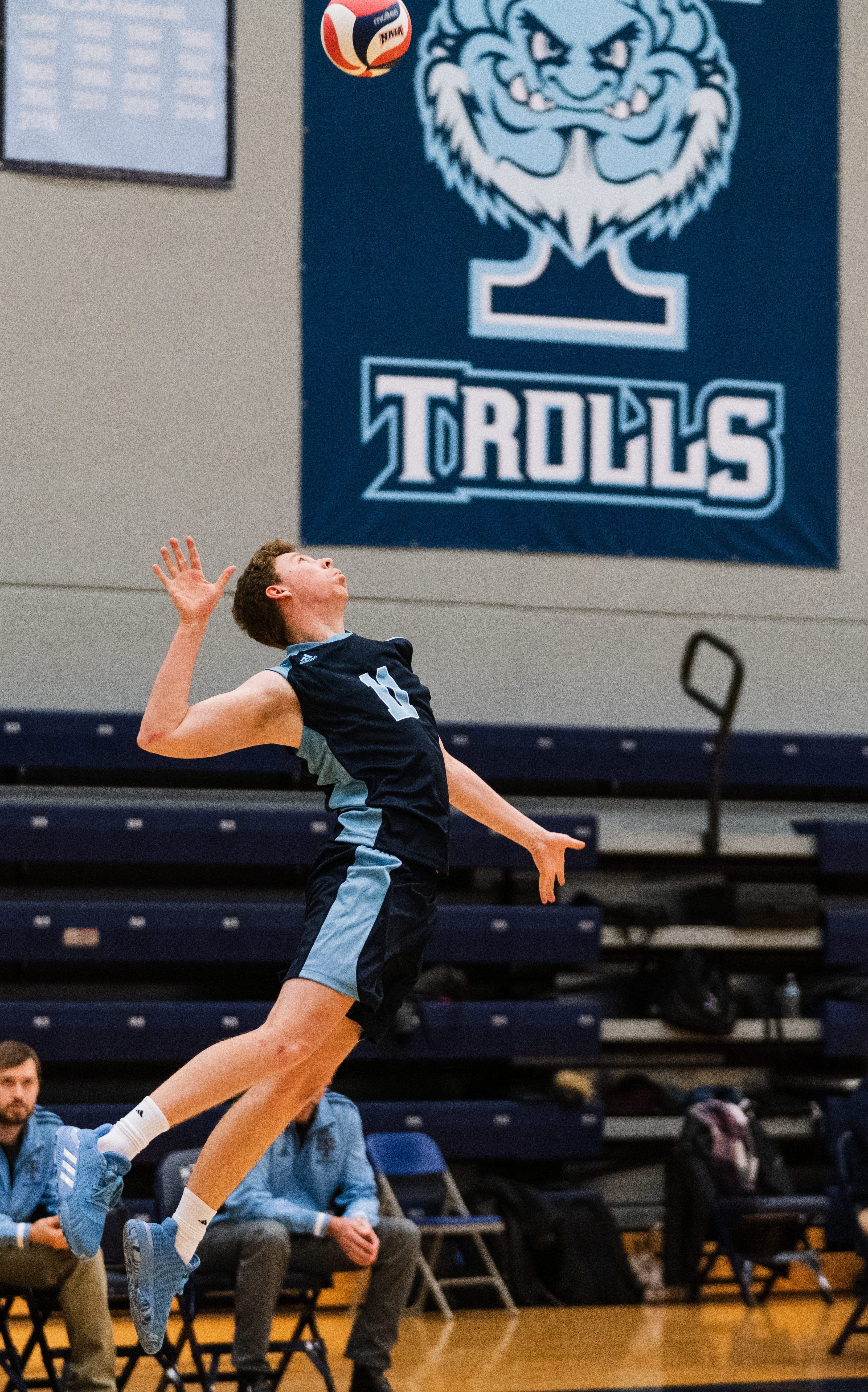 men's volleyball versus Goshen 2020: payer jumping up to spike the ball