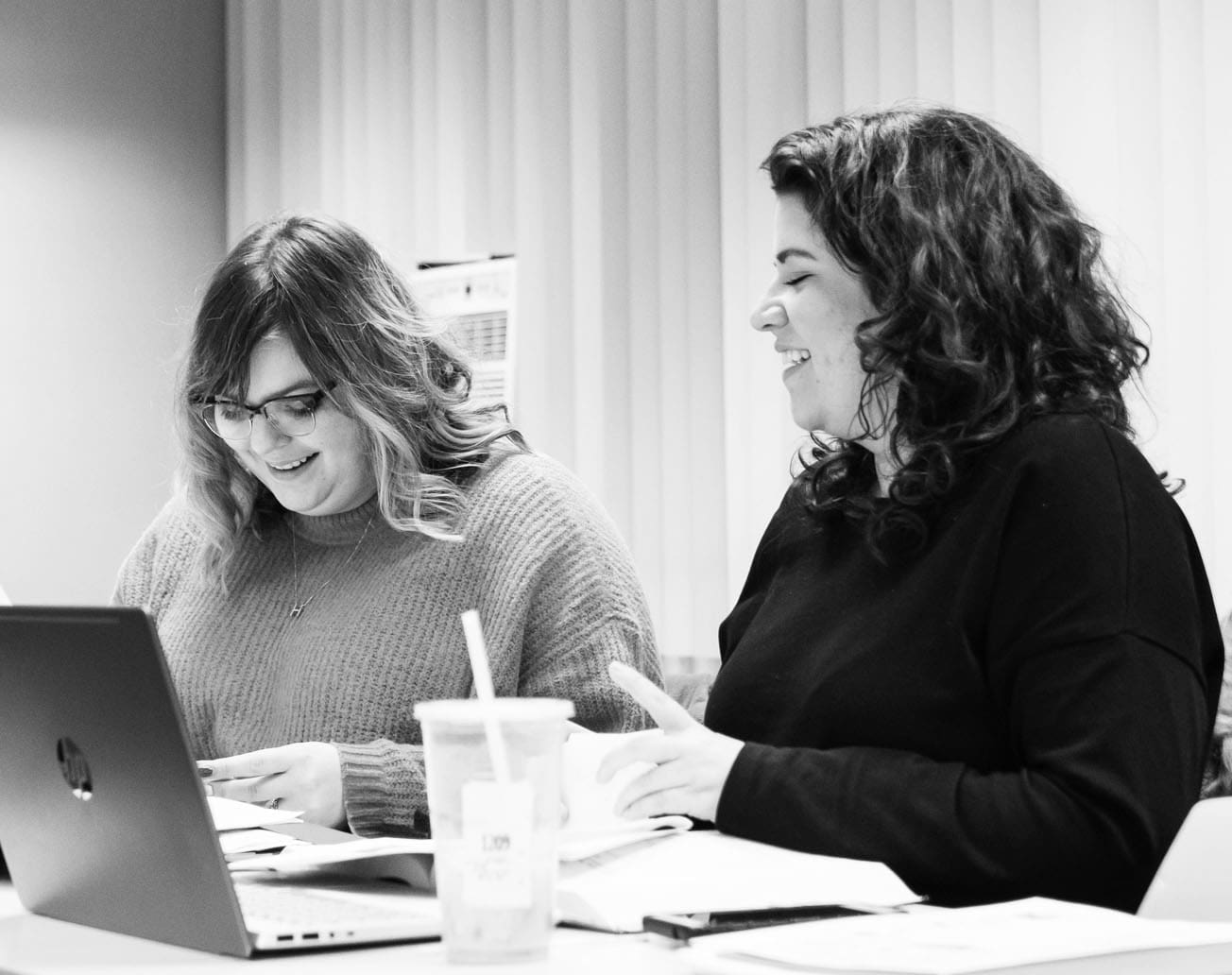 Graduate students chatting while studying in classroom