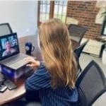 Student watching TrinTalk on computer