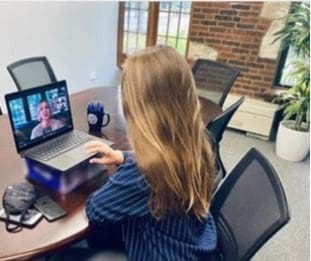 Student watching TrinTalk on computer