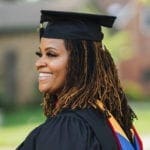 Nicole Saint Victor in a cap and gown