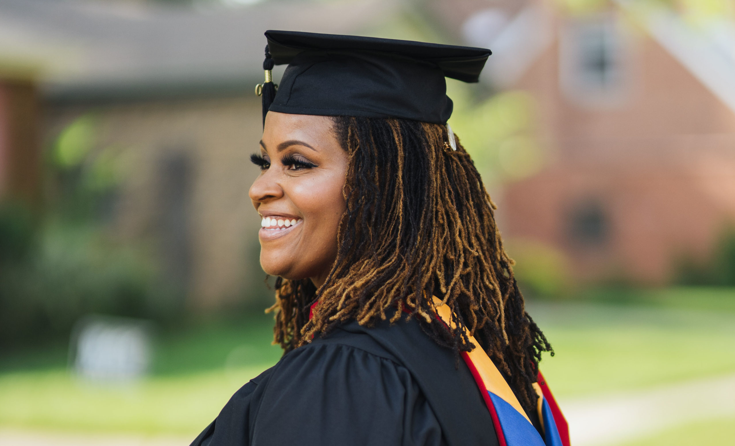 Nicole Saint Victor in a cap and gown