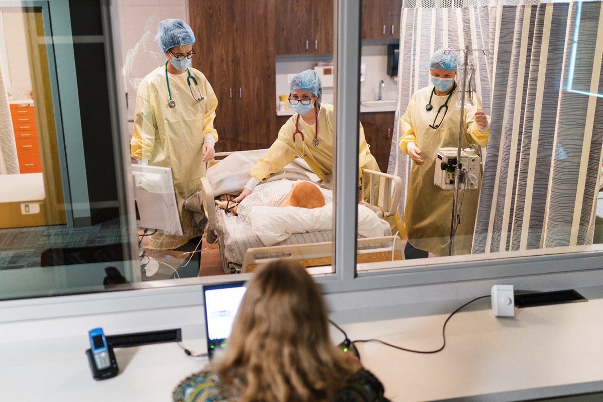 Trinity nursing students using the simulator lab