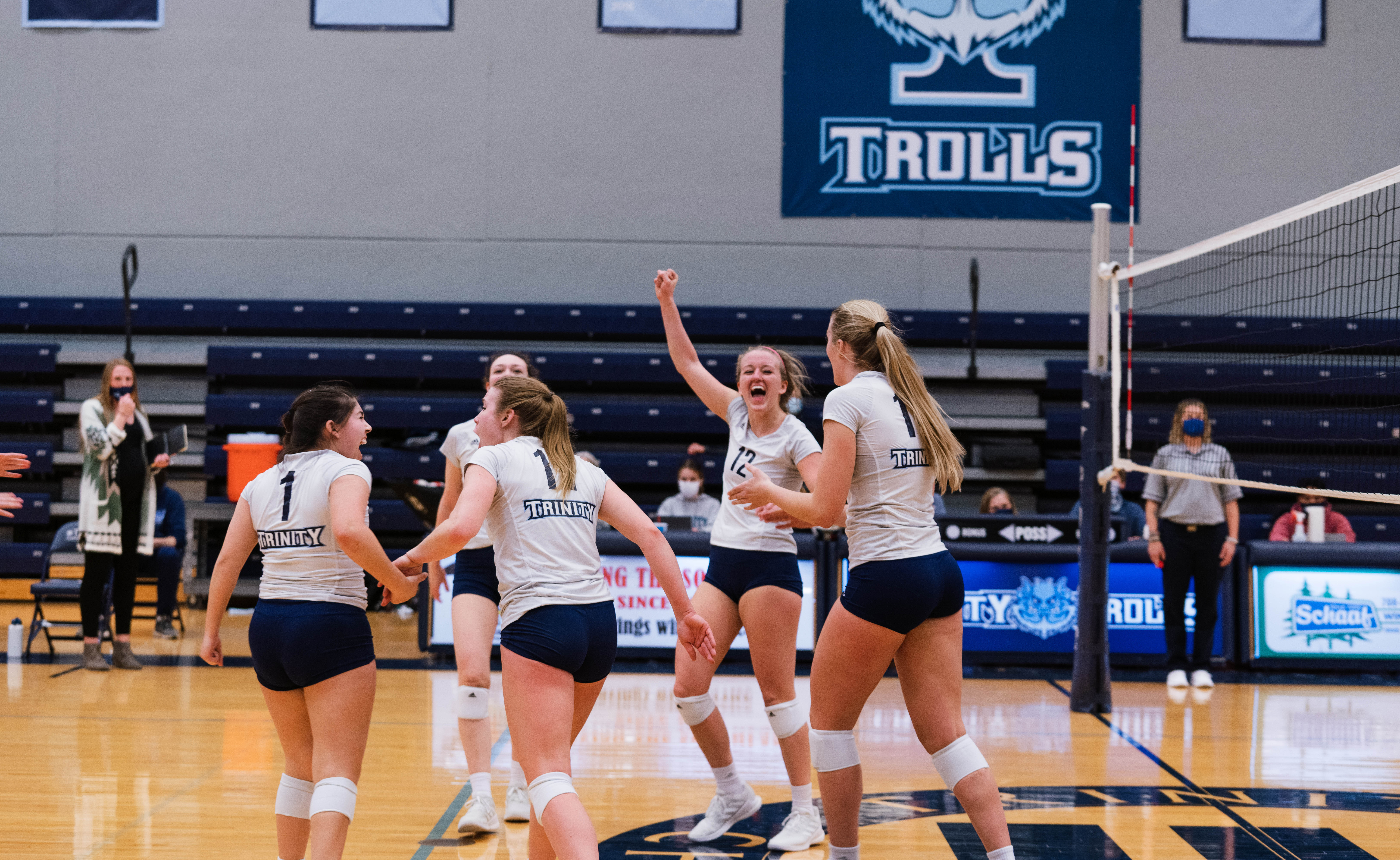 women's volleyball team celebrating on the court