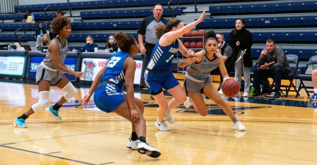 women's basketball: player driving to the basket through defense