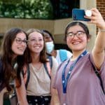 Fall 2021 semester - students taking selfie outside of library on first day of classes