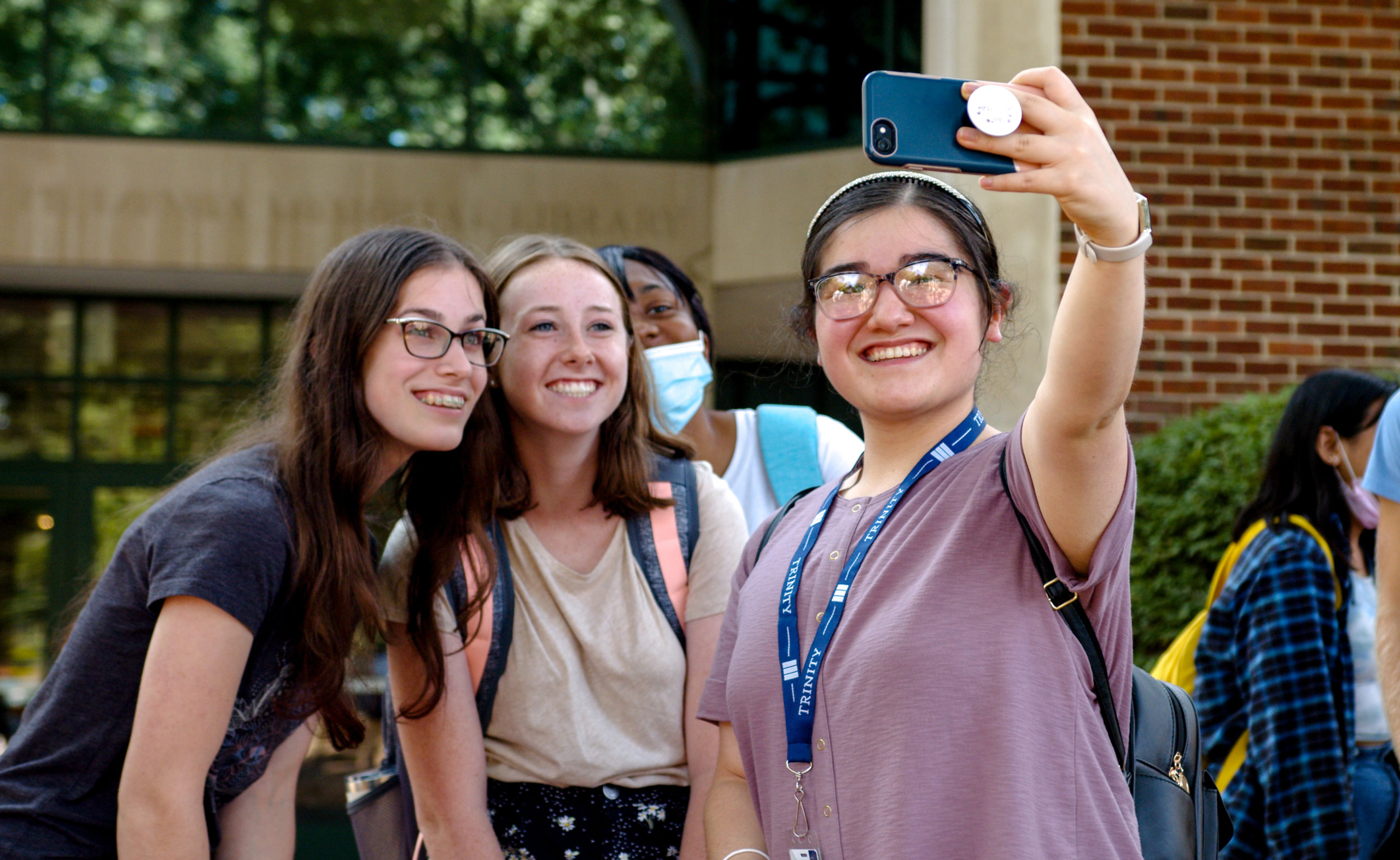 Fall 2021 semester - students taking selfie outside of library on first day of classes