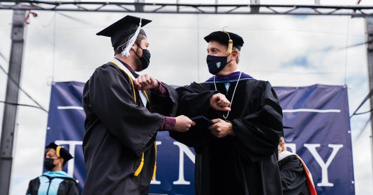 Commencement 2021 - Former President Dykstra awarding student with diploma