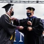 Commencement 2021 - Former President Dykstra awarding student with diploma