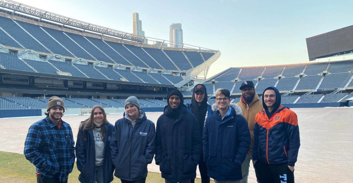 Class at Soldier Field - students standing on field at Soldier Field