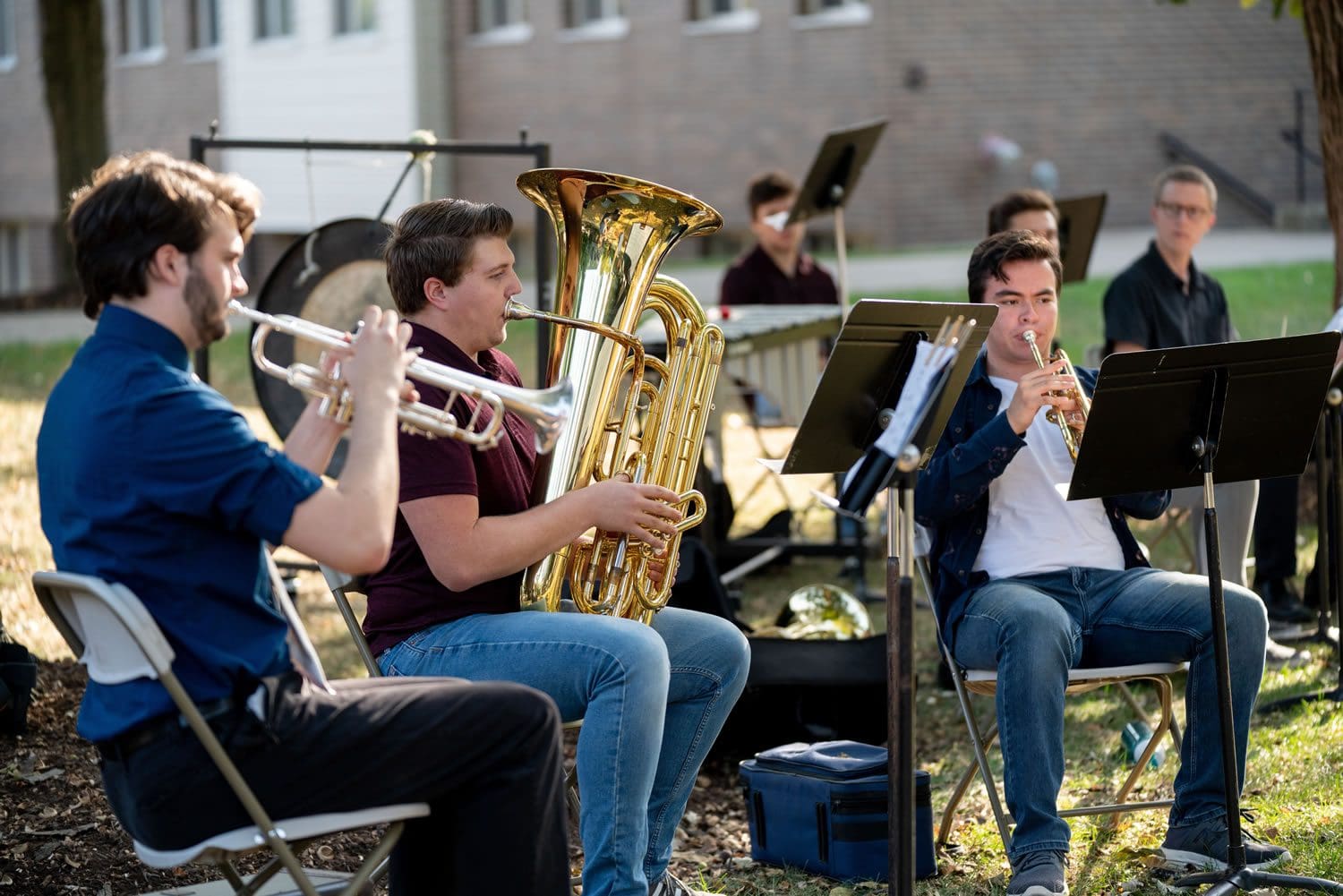 Brass Quintet performing outside on the Tab Lawn