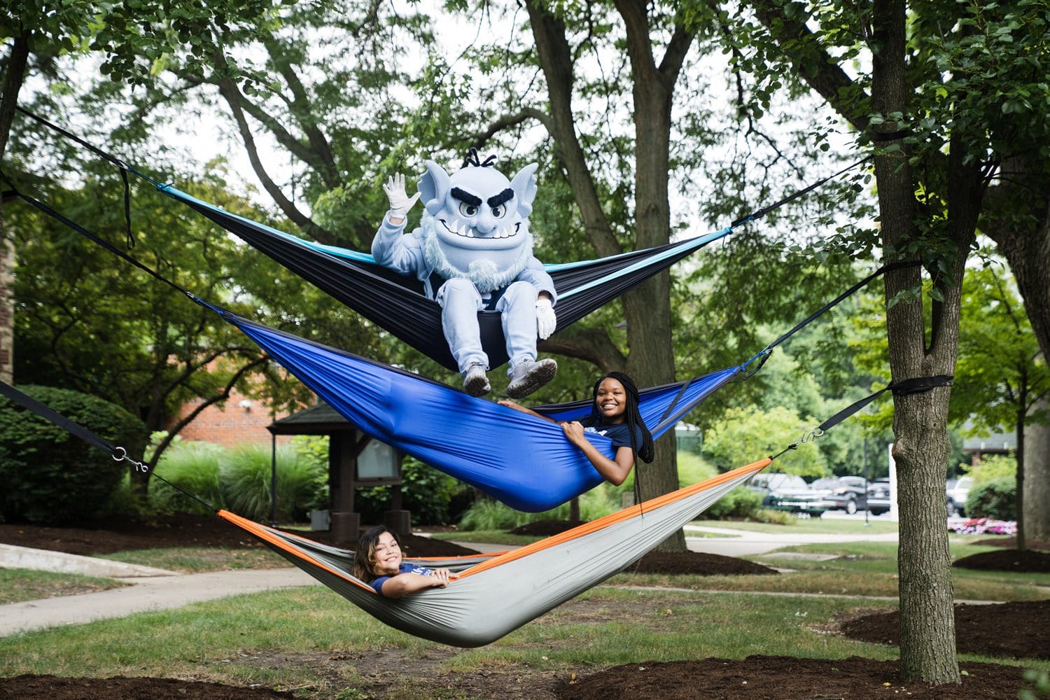 Troll and students hanging in hammocks